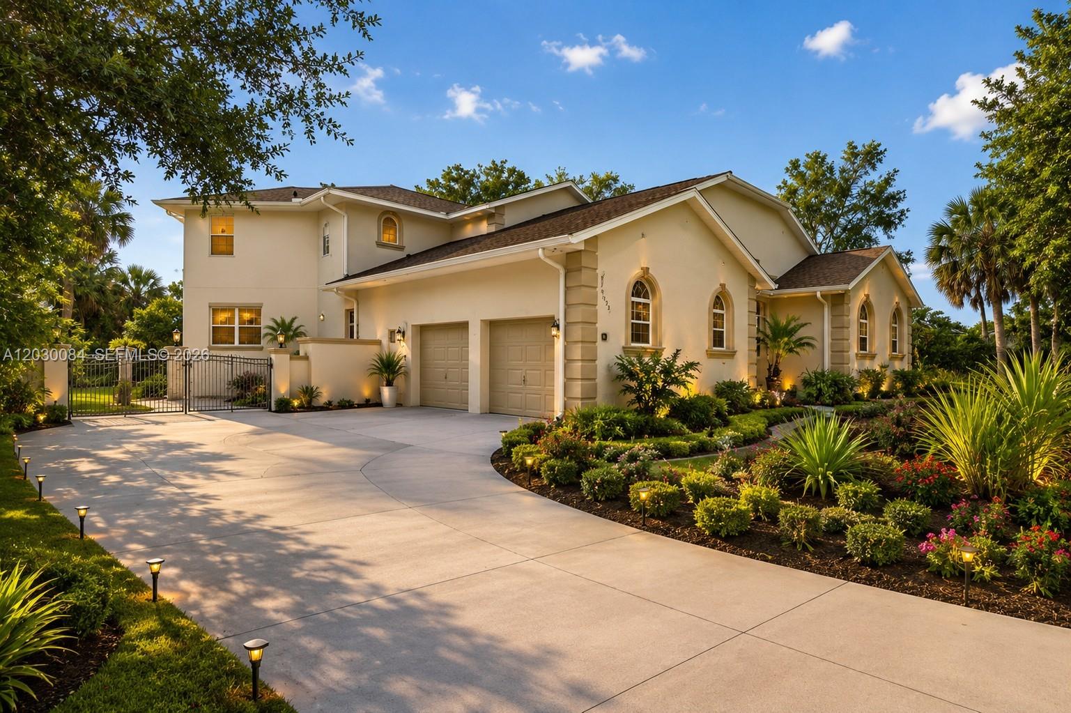 A two-story house with a beige stucco exterior, a two-car garage, and a paved driveway — 474 N Afterglow Circle, Crystal River FL 34429, CRYSTAL RIVER, FL