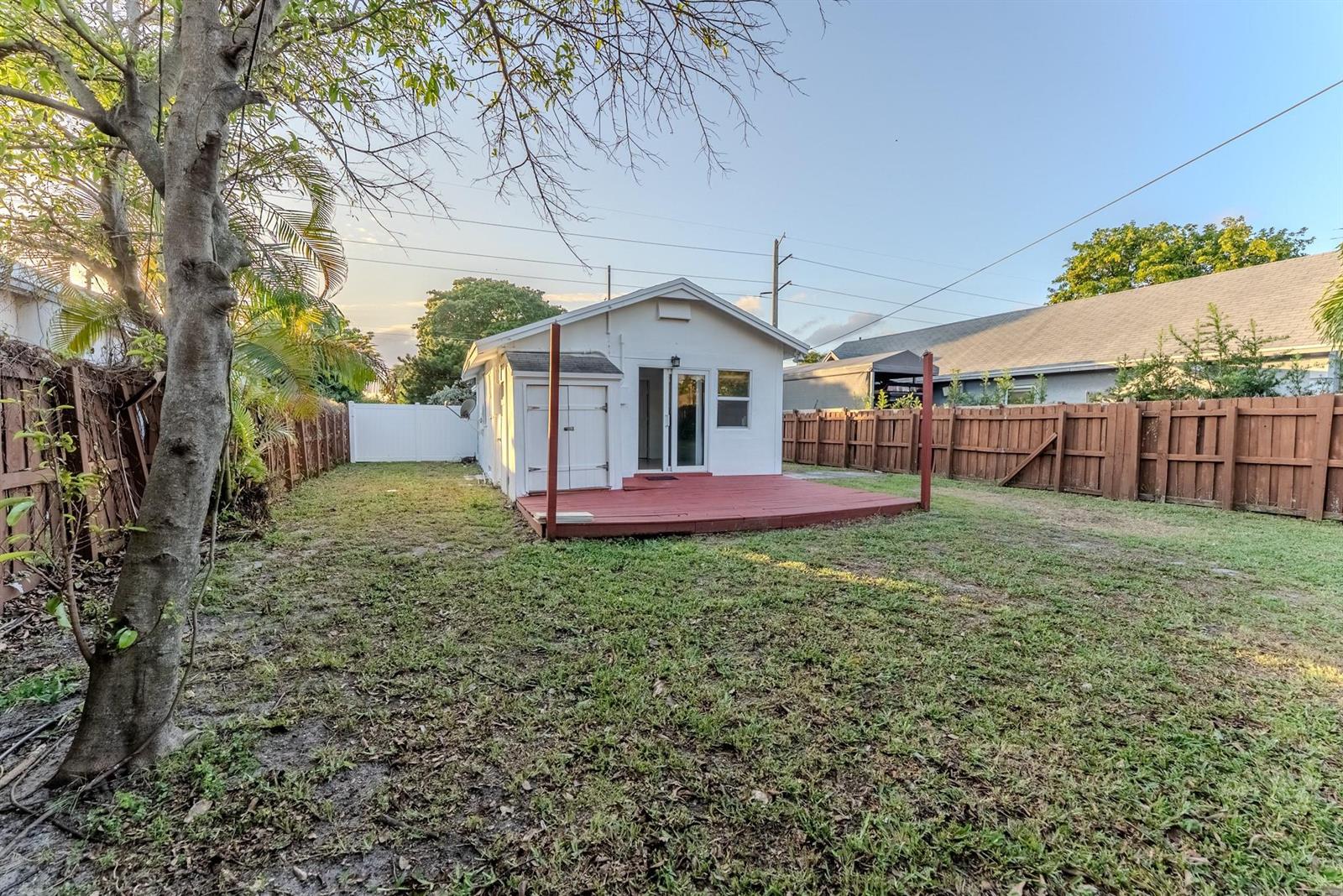 A white detached structure with a red deck sits in a fenced backyard — 521 S 24th Avenue, Hollywood FL 33020, HOLLYWOOD, FL