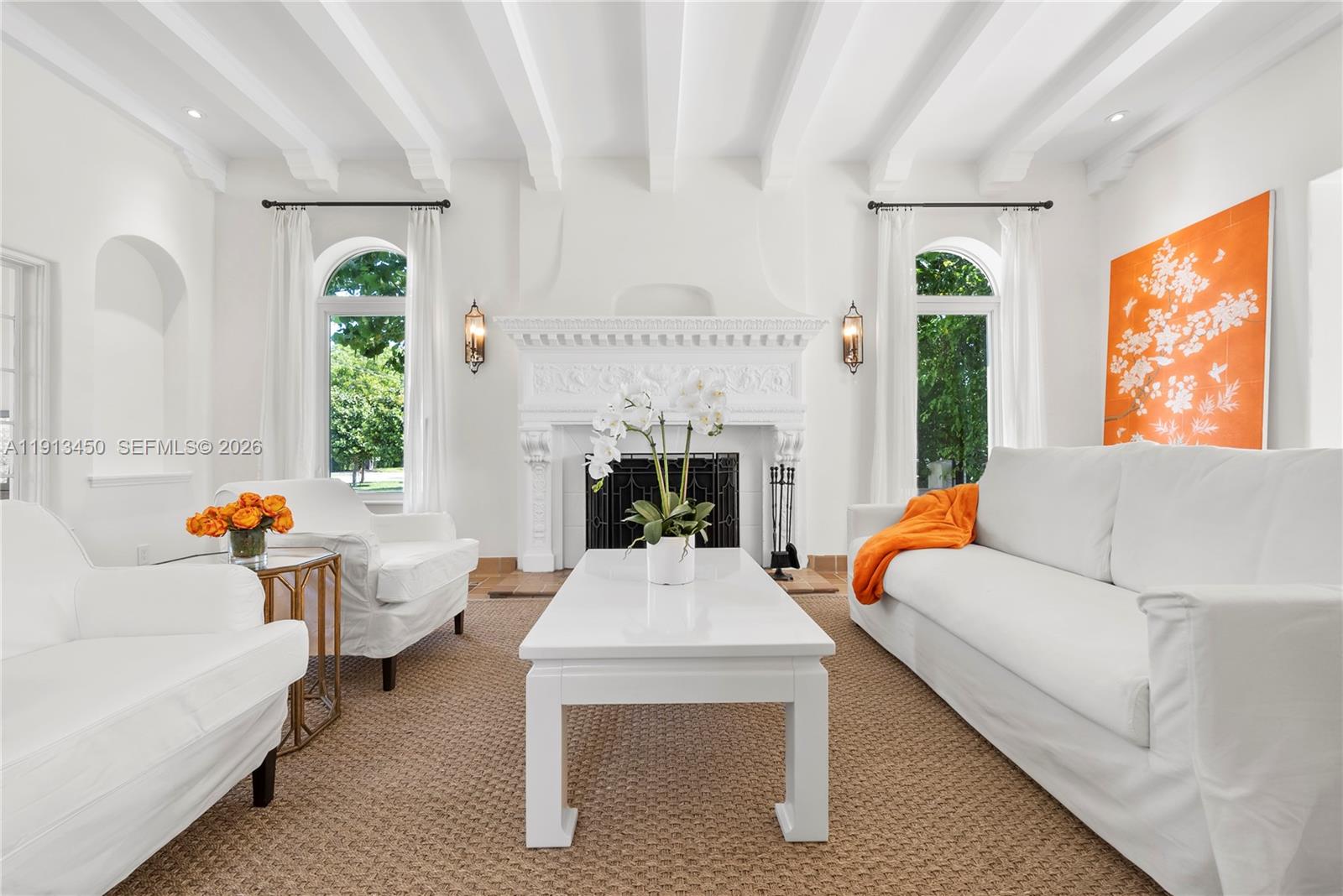 A bright living room features a white fireplace, vaulted ceiling, and white furniture — 5800 La Gorce Dr, Miami Beach FL 33140, MIAMI BEACH, FL