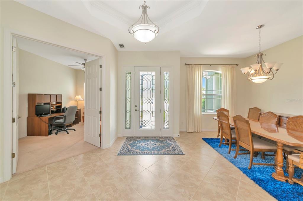 A foyer with tile flooring leads to a home office and a formal dining room — 13412 22ND COURT E, PARRISH, FL