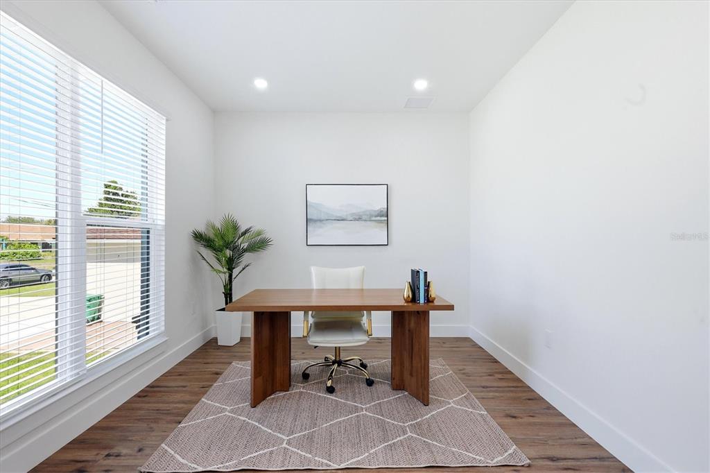 A home office features a wooden desk, a white chair, and a patterned area rug — 12387 MINOT AVENUE, PORT CHARLOTTE, FL