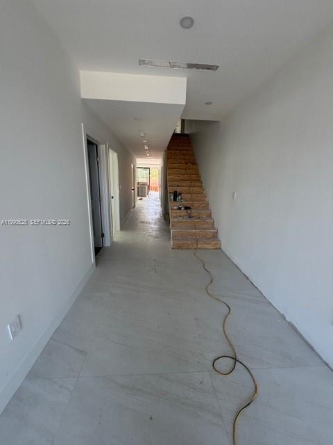 A modern kitchen features wood-toned cabinetry, stainless steel appliances, and a large covered island — 2800 SW 38th Ct, Miami FL 33134, MIAMI, FL