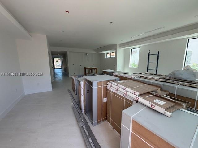 An interior hallway features light-colored tile flooring, a wooden staircase, and a doorway leading outside — 2800 SW 38th Ct, Miami FL 33134, MIAMI, FL
