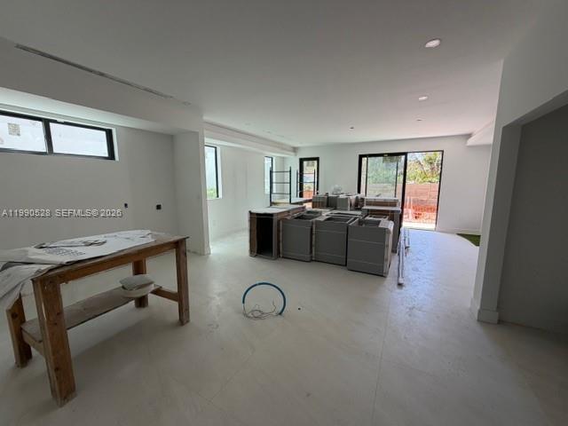 An unfinished room features light-colored tile flooring and several boxes of unassembled kitchen cabinetry — 2800 SW 38th Ct, Miami FL 33134, MIAMI, FL