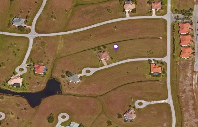 This is an aerial map view of a residential neighborhood with several houses and lots — 24473 MANIZALES COURT, PUNTA GORDA, FL