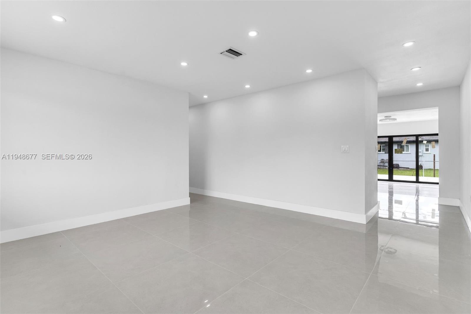 An empty room features white walls, recessed lighting, and light gray tile flooring — 13930 Van Buren St, Miami FL 33176, MIAMI, FL