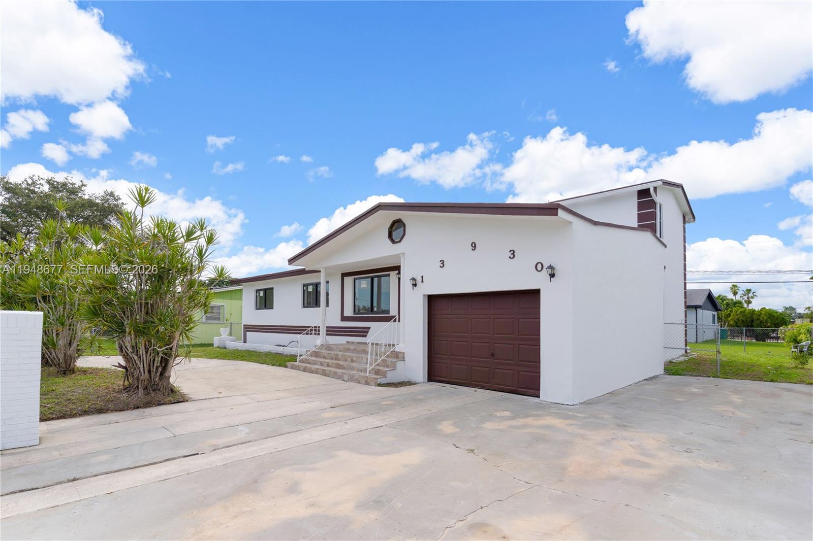 A white single-story house with a brown garage door and a concrete driveway — 13930 Van Buren St, Miami FL 33176, MIAMI, FL