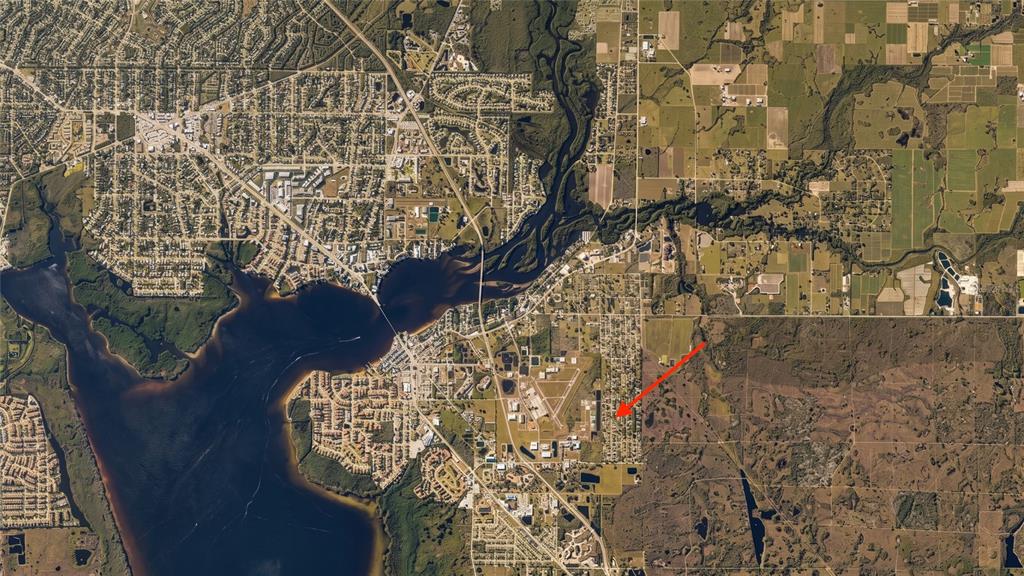 This aerial map shows a residential area with a red arrow pointing to a property — 8228 AUSTRIAN BOULEVARD, PUNTA GORDA, FL