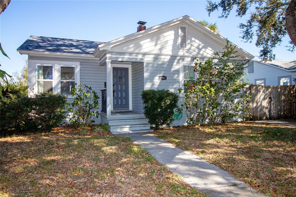 A single-story house with light gray siding, a front porch, and a concrete walkway — 1547 35TH AVENUE N, ST PETERSBURG, FL