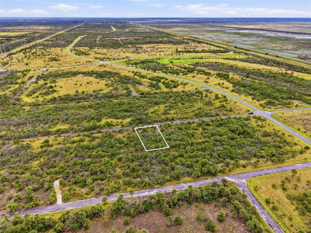 An aerial view shows a rectangular plot of land outlined in white within a rural landscape — 1553 ALCOVA STREET SW, PALM BAY, FL