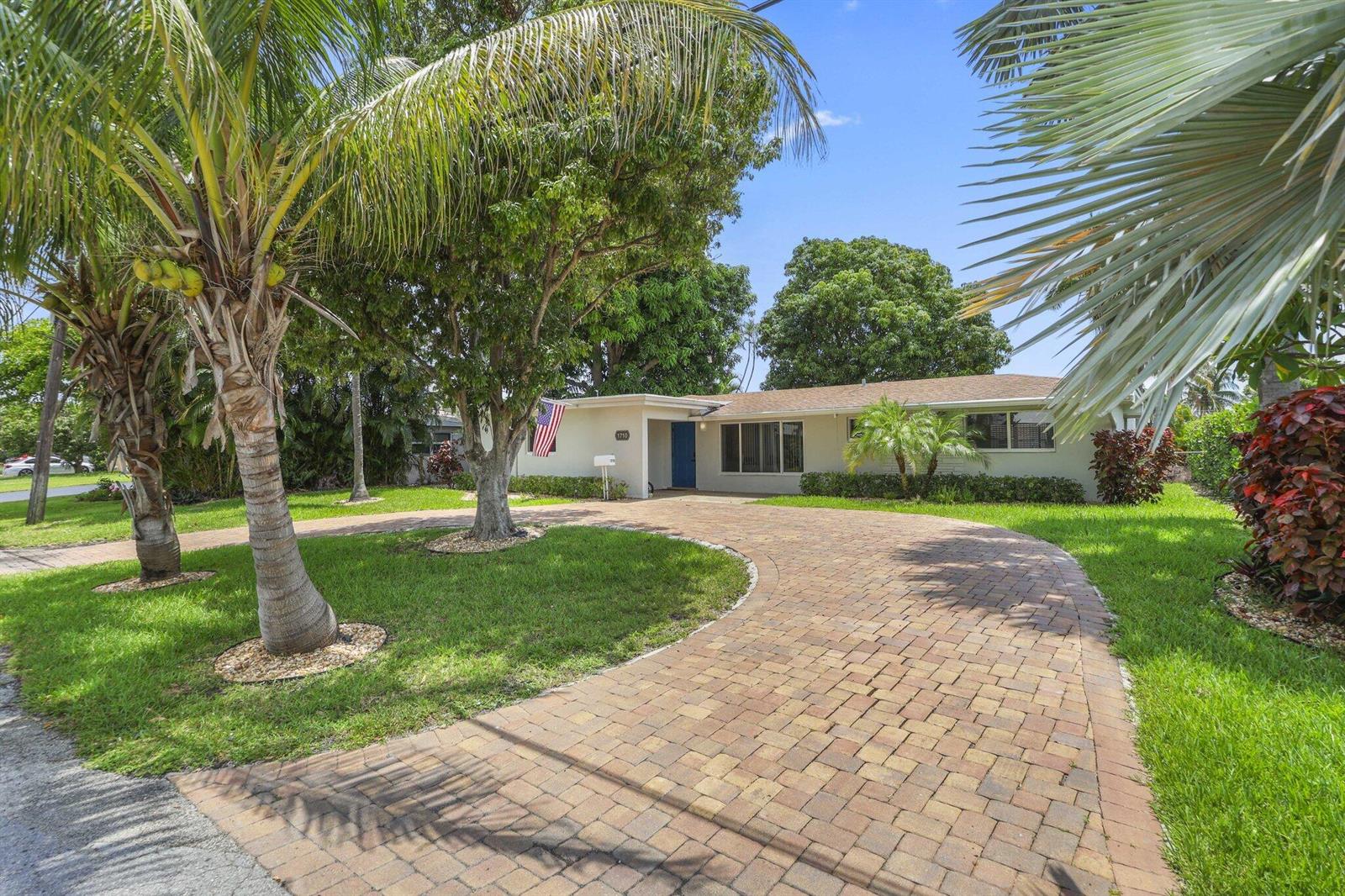 A single-story house with a brick paver driveway and palm trees in the front yard — 1710 SW 4th Avenue, Pompano Beach FL 33060, POMPANO BEACH, FL