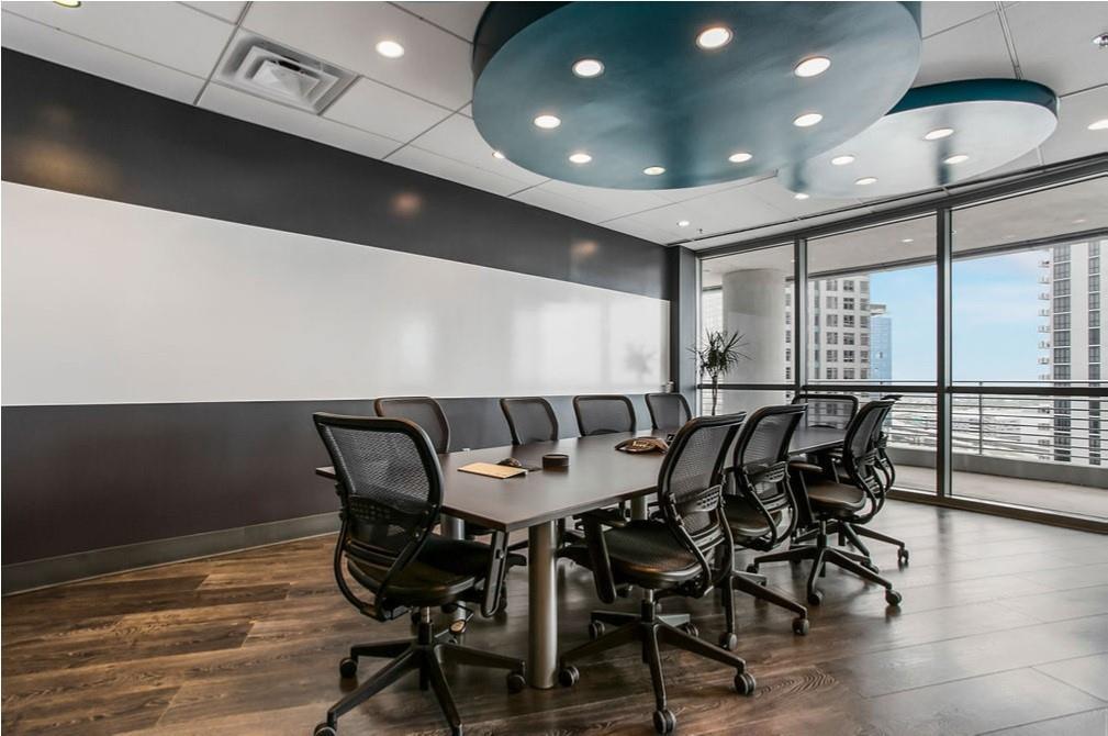 A modern conference room features a long table, mesh chairs, and circular blue ceiling lights — 121 S Orange Avenue # 1470N, FL 32801, FL