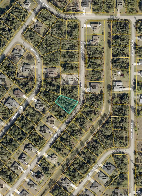 This is an aerial map showing a vacant lot highlighted in blue within a neighborhood — 00 DRAGON STREET, NORTH PORT, FL