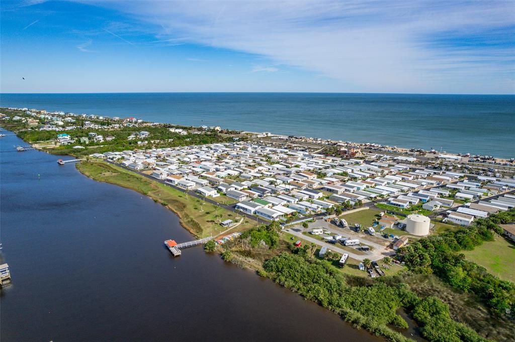 An aerial view shows a coastal mobile home community situated between a river and ocean — 191 MONITOR DRIVE, FLAGLER BEACH, FL