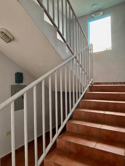 An indoor staircase with white railings and brown tiled steps leads to a landing — CHALETS DE SAN PEDRO SAN GABRIEL UNIT 402, FAJARDO, PR