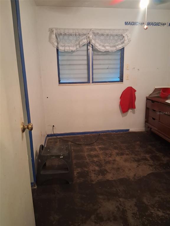 A bathroom features a vanity with a sink, a toilet, and tiled walls — 208 MELODY LANE, LARGO, FL