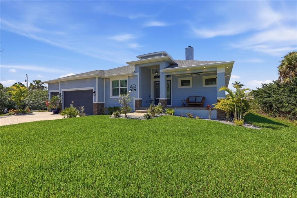 An aerial view of a waterfront house with a pool, screened lanai, and boat lift — 1022 BEEKMAN CIRCLE, PORT CHARLOTTE, FL