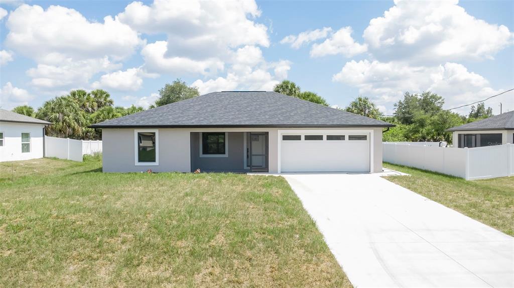 A single-story house with a gray exterior, dark roof, and a two-car garage — 19226 BRANDON AVENUE, PORT CHARLOTTE, FL
