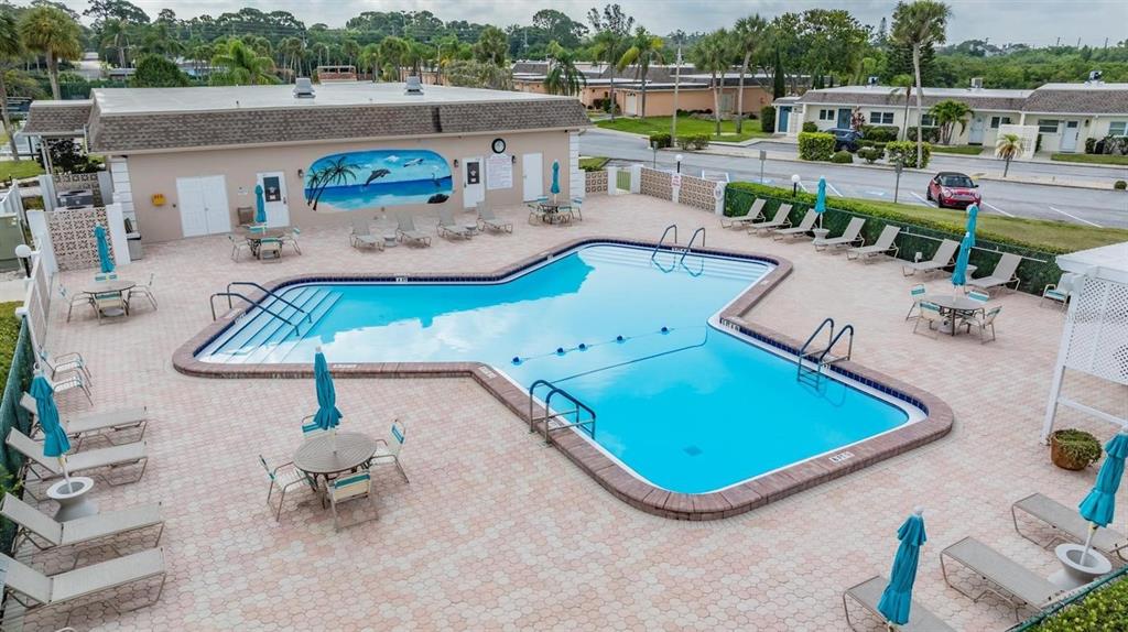 An aerial view shows a swimming pool with a mural on the adjacent building wall — 93 BOCA CIEGA POINT BOULEVARD N UNIT 93, ST PETERSBURG, FL