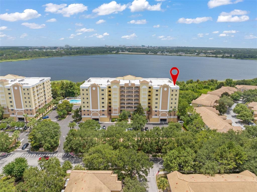 An aerial view shows a multi-story apartment building with a red location pin on top — 6336 BUFORD STREET UNIT 809, ORLANDO, FL