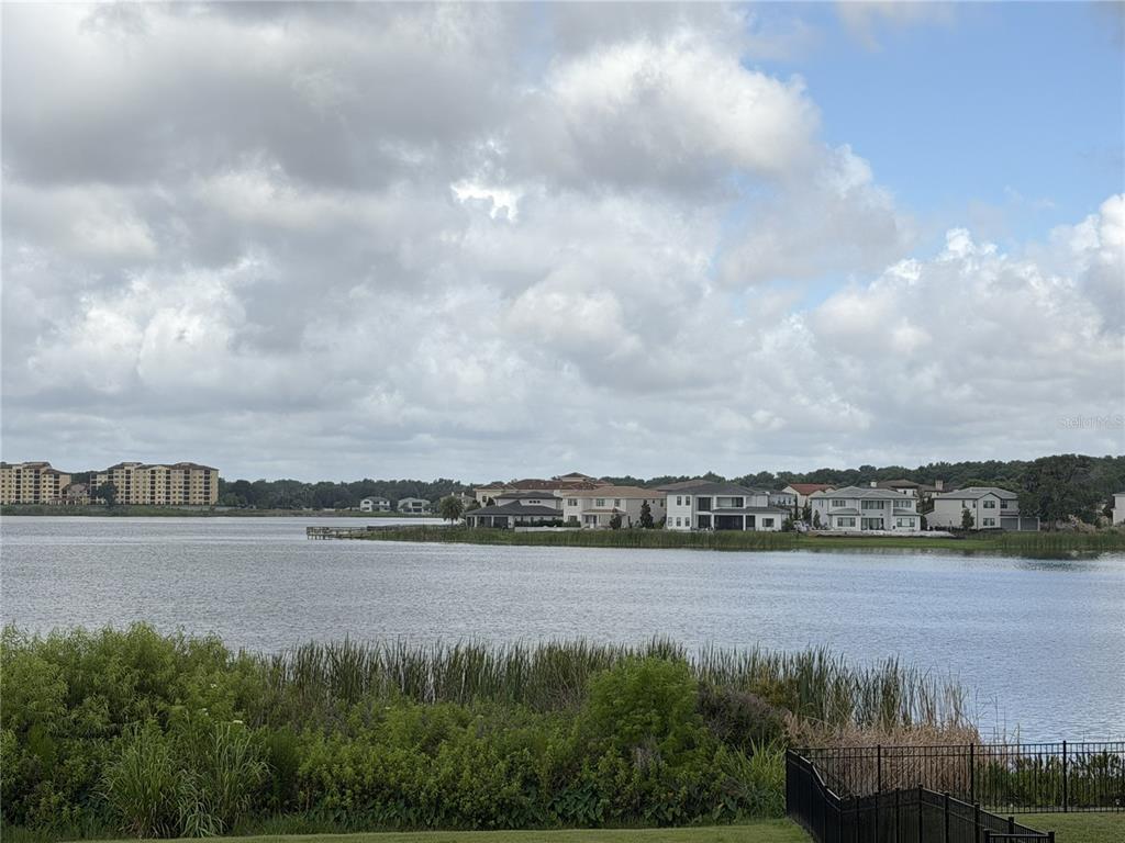An aerial view shows two waterfront houses with swimming pools, private docks, and wooded lots — 15345 PENDIO DRIVE, BELLA COLLINA, FL