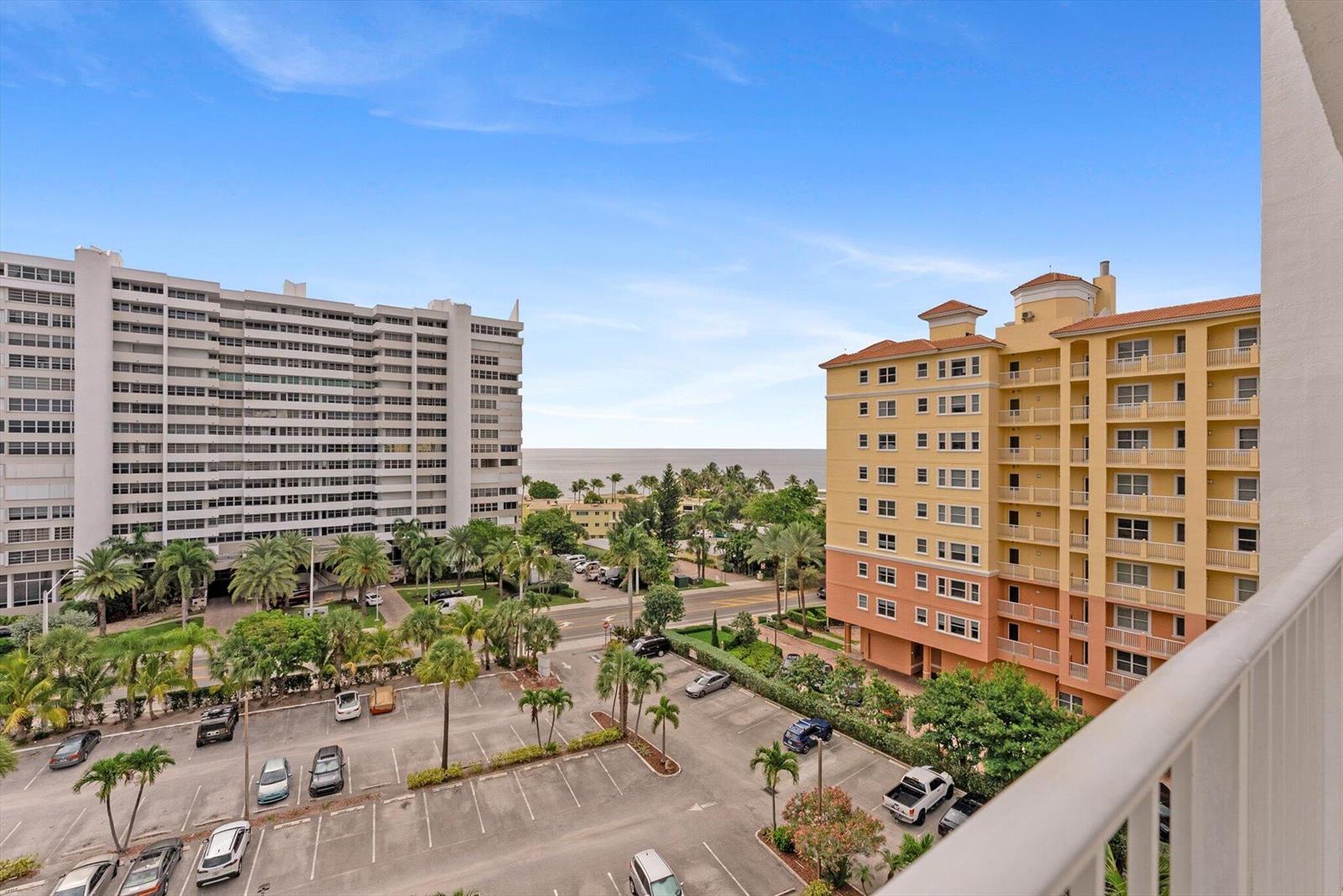 An elevated view shows a parking lot between two large apartment buildings near the ocean — 1391 S Ocean Boulevard S # 906, Pompano Beach FL 33062, POMPANO BEACH, FL
