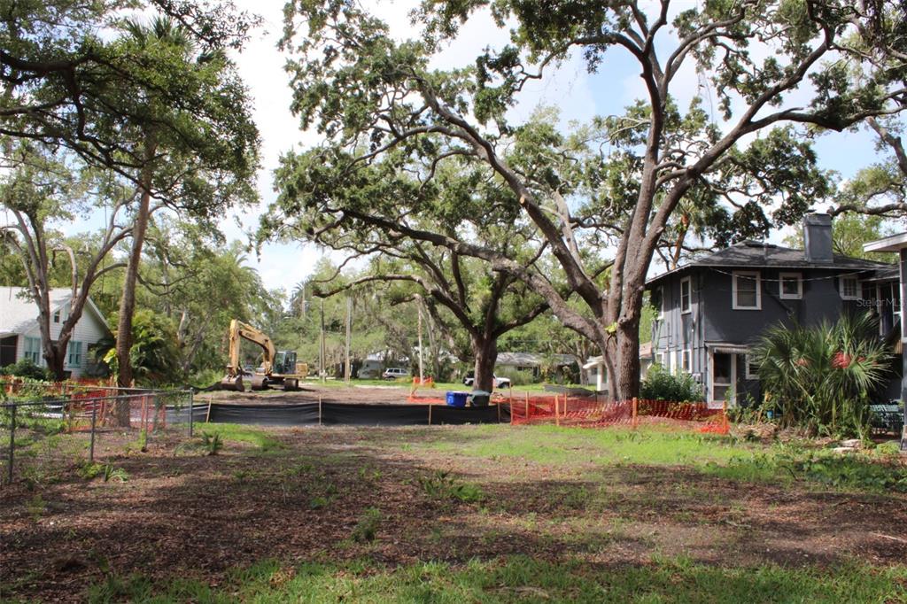 An aerial view shows a residential neighborhood with a red arrow pointing toward a property — 300 PRESIDENT STREET, DUNEDIN, FL