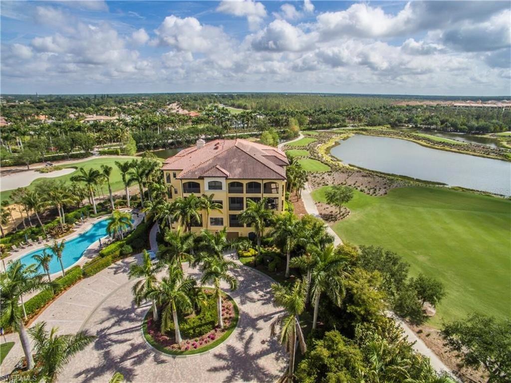 An aerial view shows a multi-story building with a pool, circular driveway, and golf course — 2555 MARQUESA ROYALE LANE UNIT PH 302, NAPLES, FL