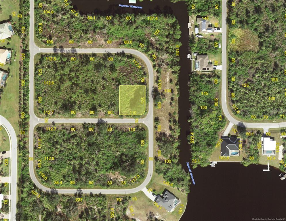 This is a satellite map showing a vacant residential lot highlighted in a subdivision — 13446 WADE AVENUE, PORT CHARLOTTE, FL