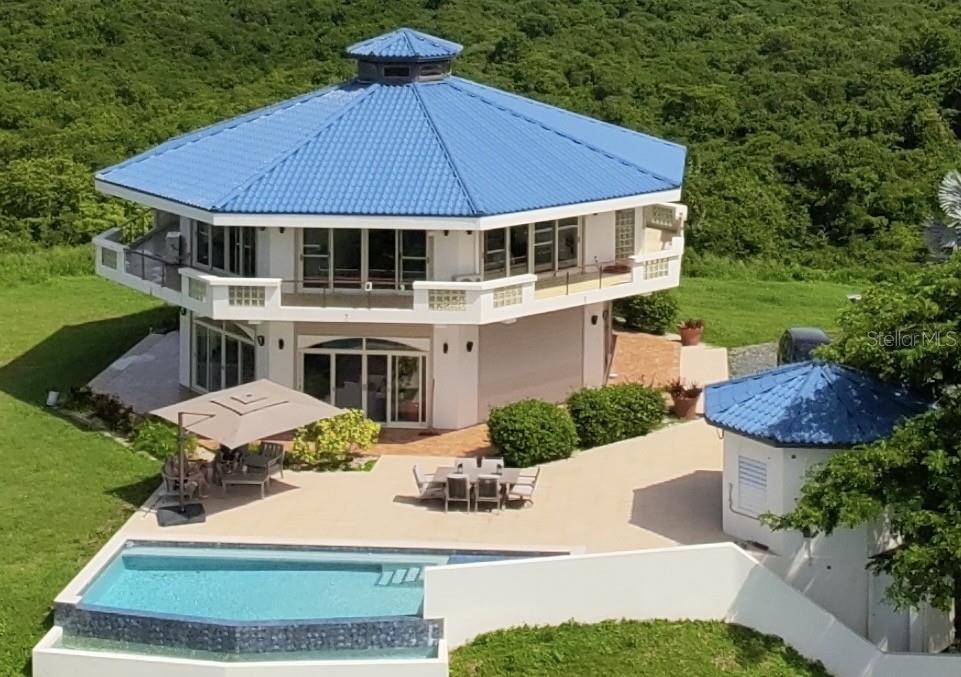 An aerial view of a multi-story, octagonal house with a blue roof, pool, and patio — 736 BRISAS DE JASMIN, VIEQUES, PR