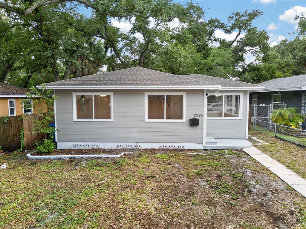 A single-story house with gray horizontal siding and a hip roof sits on a lot — 2525 21ST STREET S, ST PETERSBURG, FL