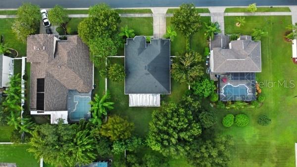 Aerial view of three suburban houses with pools and green lawns — 3193 TOHO COURT, KISSIMMEE, FL