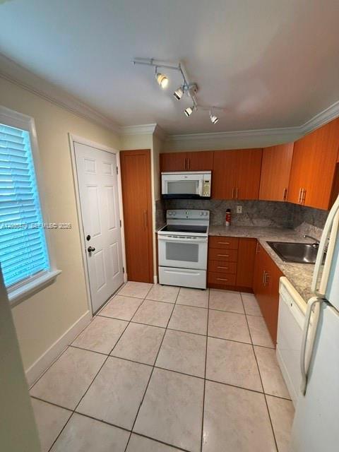 An interior entryway with tiled flooring, a bathroom door, and an open exterior door — 1501 NE 191st St # C107, Miami FL 33179, MIAMI, FL