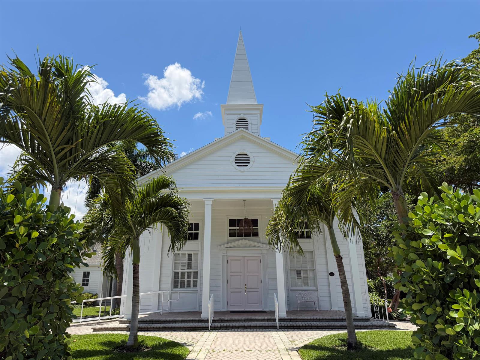 A white wooden church with a steeple stands behind two palm trees under a blue sky — 200 SE 7th Avenue, Delray Beach FL 33483, DELRAY BEACH, FL