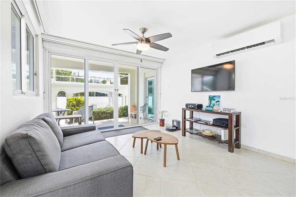 A multi-story white apartment building with balconies stands behind a blue decorative wall — Calle Cambija RINCON OCEAN VIEW UNIT 1D, RINCON, PR