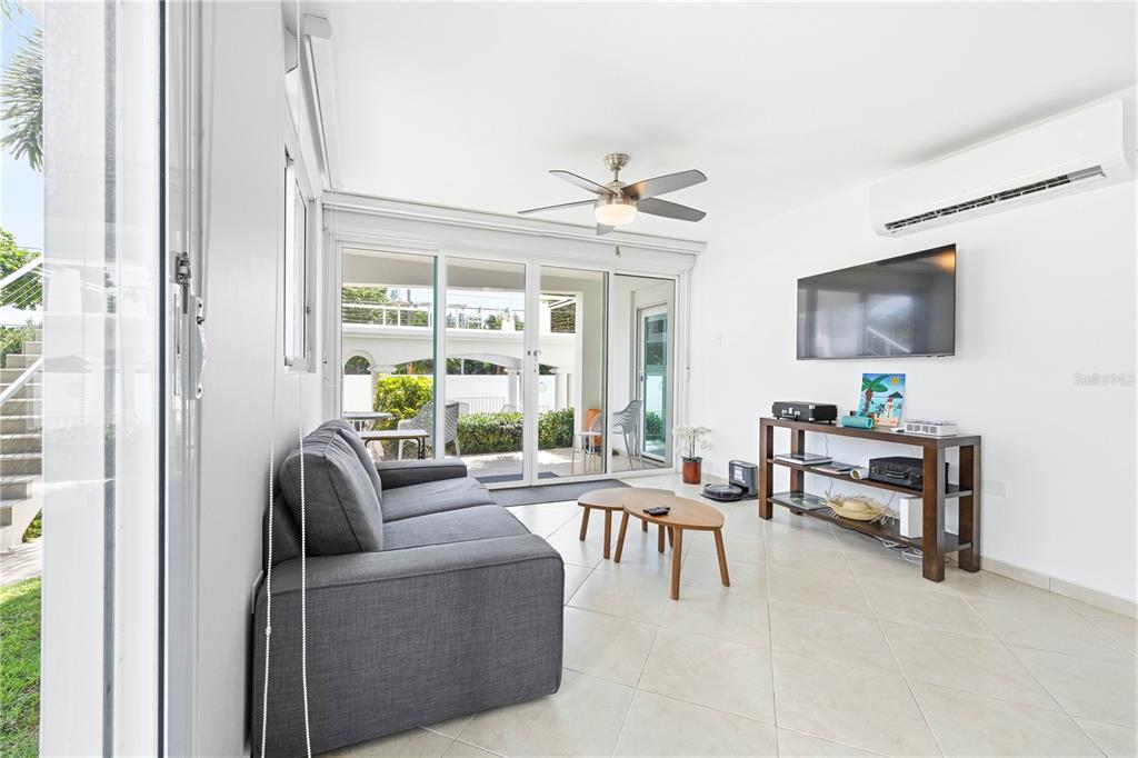 A living room features a gray sofa, two wooden coffee tables, and sliding glass doors — Calle Cambija RINCON OCEAN VIEW UNIT 1D, RINCON, PR