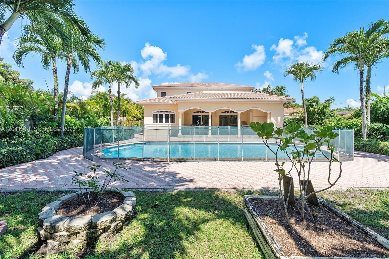 A two-story house features a backyard swimming pool enclosed by a safety fence — 3765 Prairie Ave # 3765, Miami Beach FL 33140, MIAMI BEACH, FL