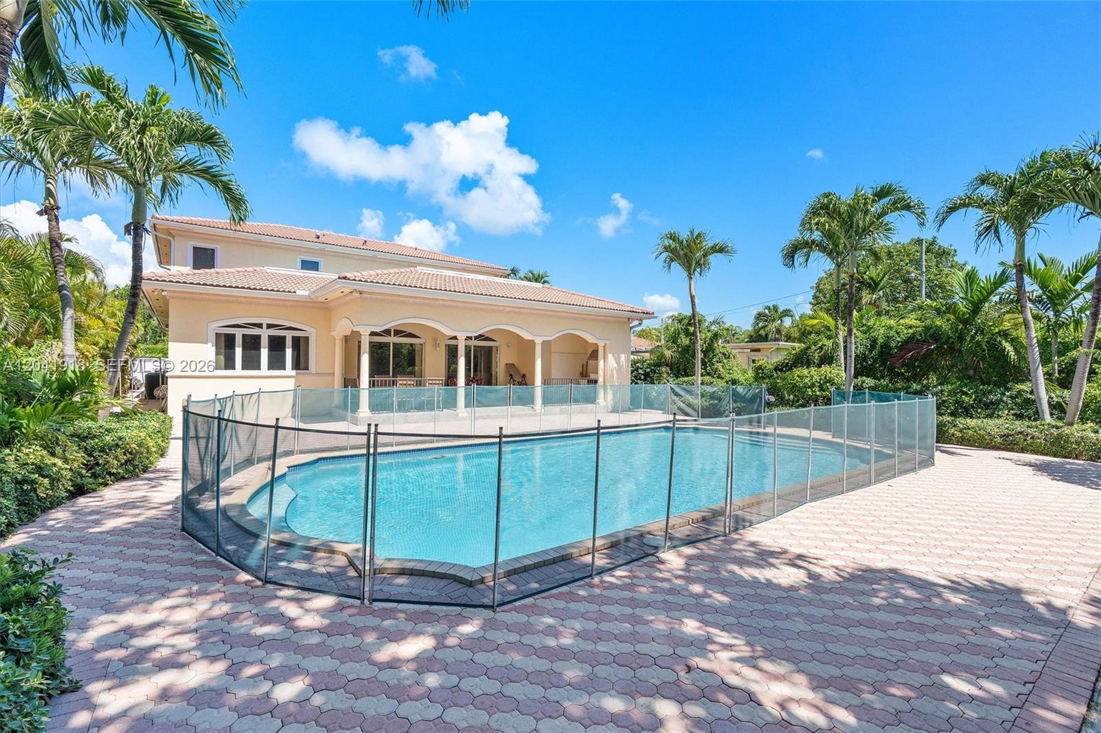 A two-story house features a swimming pool enclosed by a safety fence on a patio — 3765 Prairie Ave # 3765, Miami Beach FL 33140, MIAMI BEACH, FL