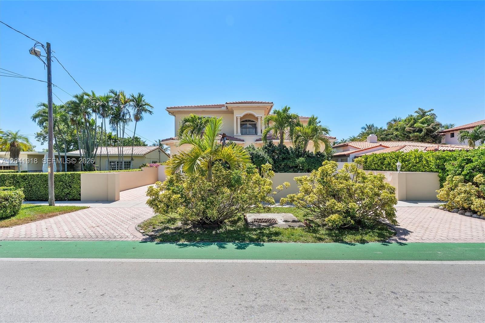 A two-story house with a paved driveway and lush landscaping sits behind a low wall — 3765 Prairie Ave # 3765, Miami Beach FL 33140, MIAMI BEACH, FL