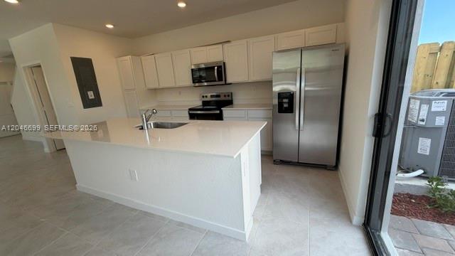 A modern kitchen features white cabinets, stainless steel appliances, and a large central island — 1302 NE 4th Ave # 0, Florida City FL 33034, FLORIDA CITY, FL