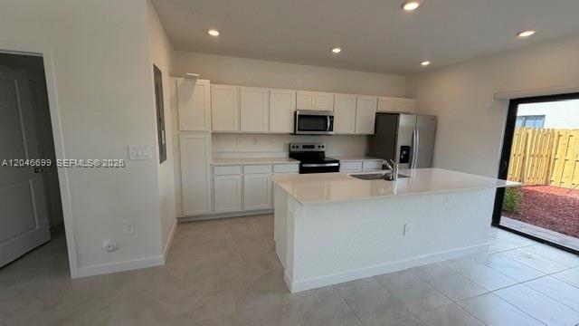 A modern kitchen features white cabinets, stainless steel appliances, and a large central island — 1302 NE 4th Ave # 0, Florida City FL 33034, FLORIDA CITY, FL