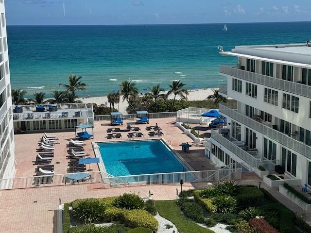 An elevated view shows a swimming pool, lounge chairs, and a beach along the ocean — 5401 Collins Ave # 628, Miami Beach FL 33140, MIAMI BEACH, FL