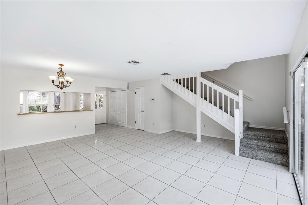 A wooden dock extends into a calm lake under a clear blue sky — 6040 SCOTCHWOOD GLEN UNIT 105, ORLANDO, FL