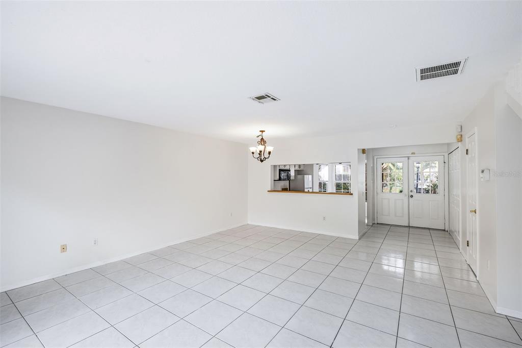 An outdoor swimming pool surrounded by a concrete deck, lounge chairs, and umbrellas — 6040 SCOTCHWOOD GLEN UNIT 105, ORLANDO, FL