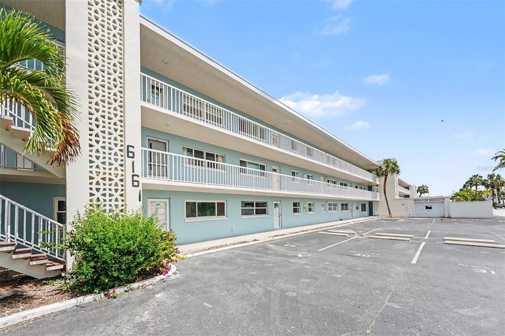 A three-story apartment building with light blue exterior walls and white railings — 6161 GULF WINDS DRIVE UNIT 153, ST PETE BEACH, FL