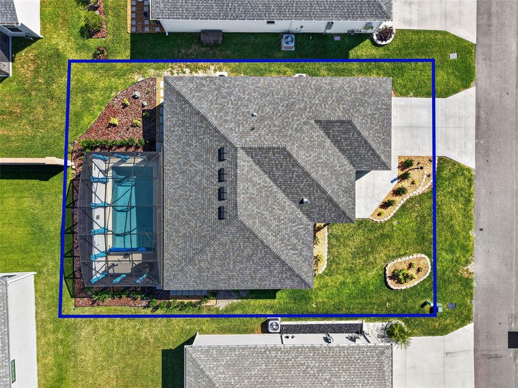 An aerial view shows a house with a screened-in pool and a fenced backyard — 7478 SAVANNA DRIVE, THE VILLAGES, FL
