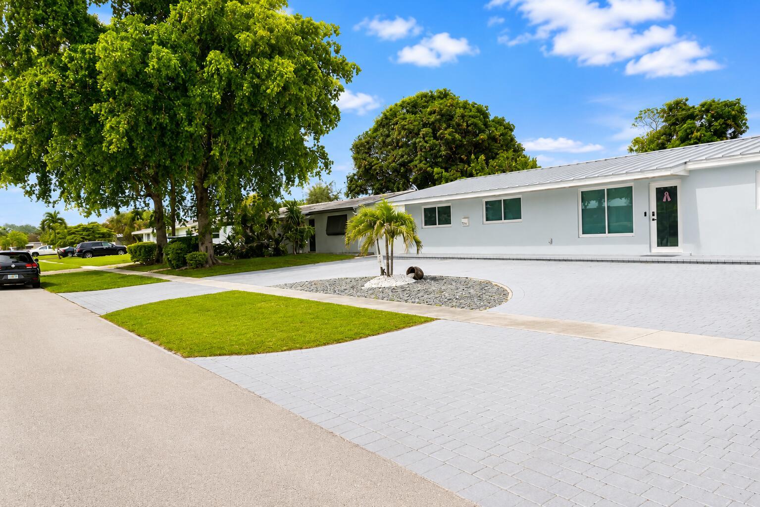 A light blue house with a metal roof and a large paved circular driveway — 1316 SE 3rd Avenue, Deerfield Beach FL 33441, DEERFIELD BEACH, FL
