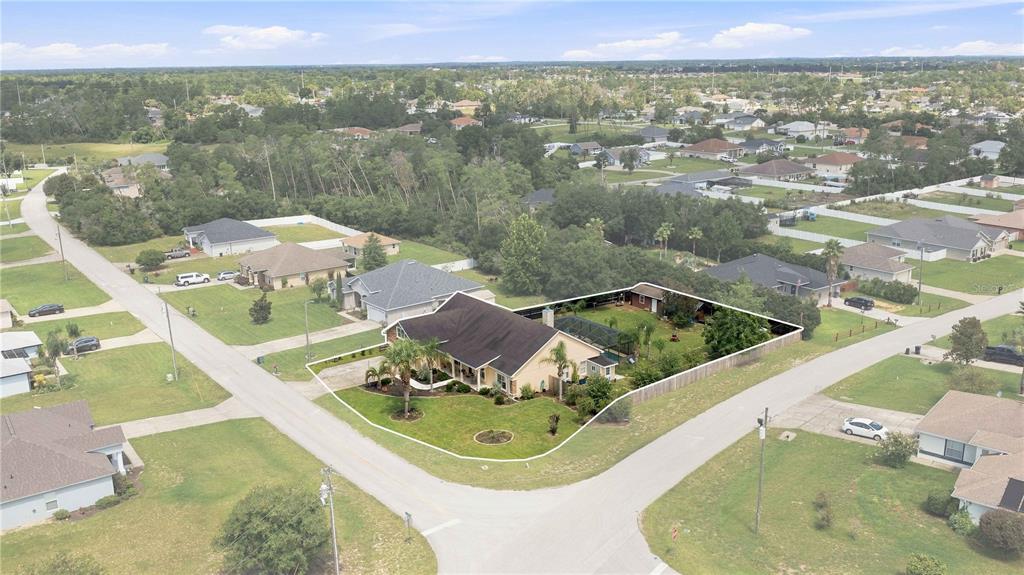 An aerial view shows a single-story house with a fenced backyard and a screened pool — 4505 SW 106TH PLACE, OCALA, FL