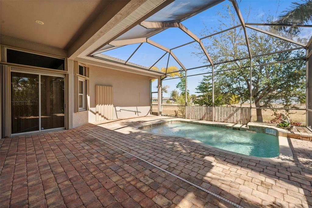 A screened-in patio features a brick paver deck and a small swimming pool — 2727 NW 45TH PLACE, CAPE CORAL, FL