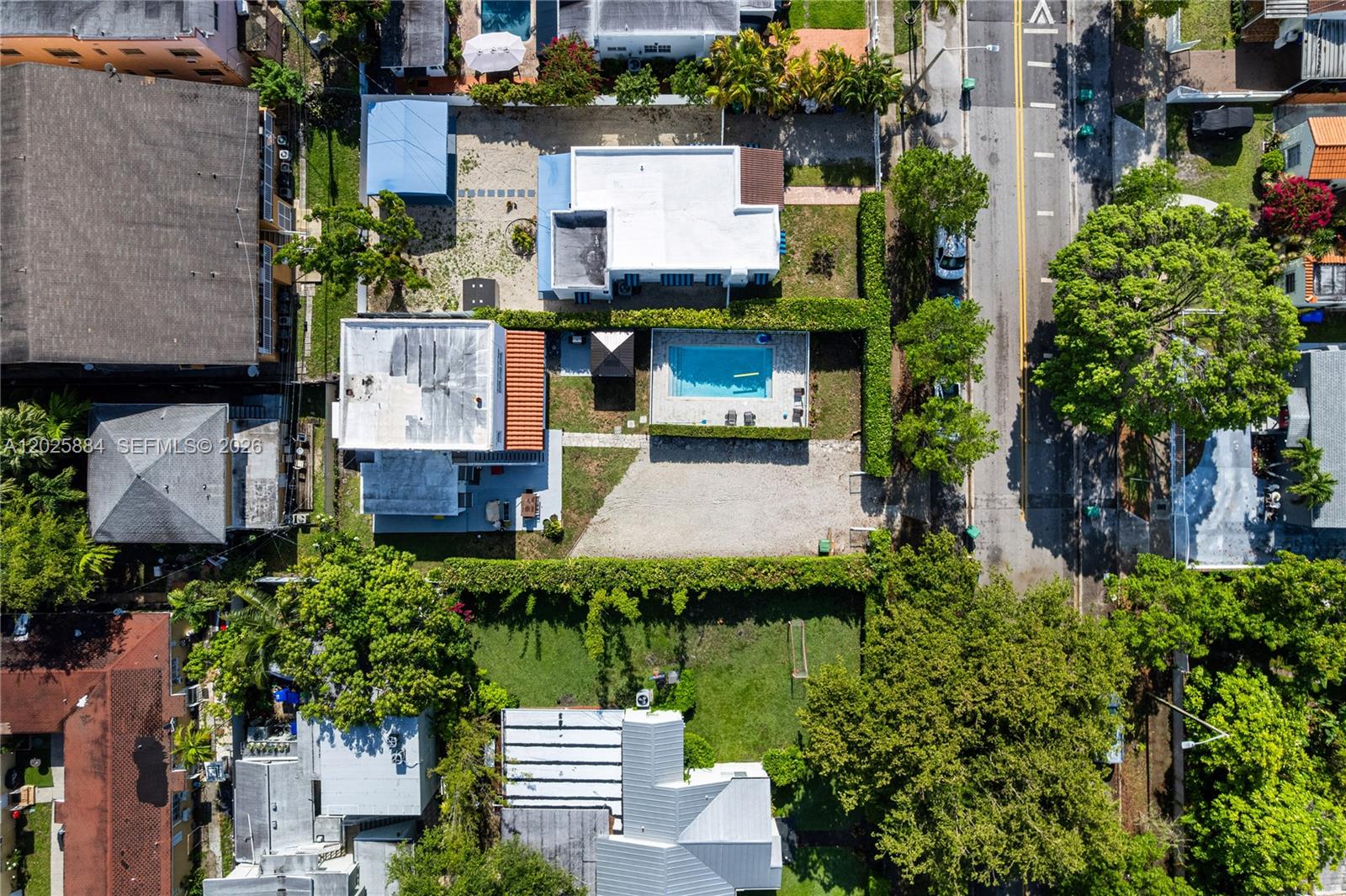 An aerial view shows a residential property with a swimming pool and a gravel driveway — 2255 SW 10th St # B, Miami FL 33135, MIAMI, FL